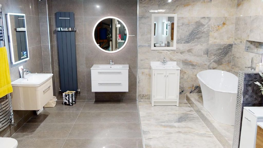 Small bathroom with round mirror, wall-hung vanity and heated towel rail