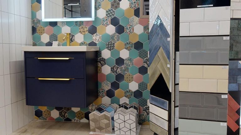 Colourful hexagon tiles beside a navy wall hung vanity